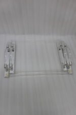 Clear acrylic serving tray set with polished handles displayed on a marble countertop in a modern kitchen setting
