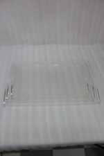 Set of clear acrylic serving trays with built-in handles and textured bases displayed on a marble kitchen counter next to an espresso machine and ceramic cups.