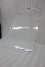 Set of clear acrylic serving trays with built-in handles and textured bases displayed on a marble kitchen counter next to an espresso machine and ceramic cups.
