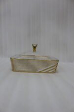 Two luxury clear acrylic dry fruit serving dishes with gold trim, crystal knobs, and partitioned compartments displayed on a modern wooden coffee table.