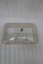 Elegant partitioned glass dry fruit dish with a gold trim and crystal-accented lid sitting on a wooden coffee table in a modern living room.