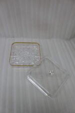 Two elegant crystal dry fruit dishes with gold rims and clear ball-knob lids, displayed in Medium and Large sizes on a table.