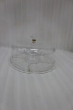 Clear acrylic dry fruit and cake serving platter with multi-compartments, center bowl, and a crystal knob dome lid resting on a wooden table.