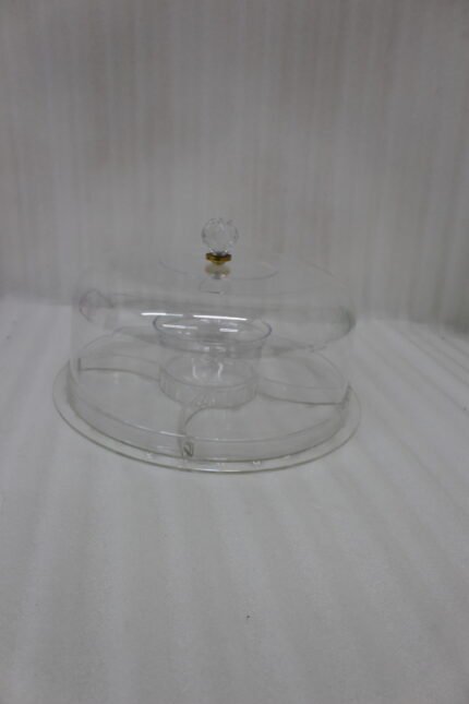 Clear acrylic dry fruit and cake serving platter with multi-compartments, center bowl, and a crystal knob dome lid resting on a wooden table.