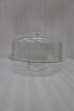 Clear acrylic dry fruit and cake serving platter with multi-compartments, center bowl, and a crystal knob dome lid resting on a wooden table.