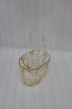 Clear acrylic spoon holder and cutlery caddy with gold accent patterns and a heart-shaped handle on a kitchen countertop holding utensils.