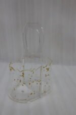 Clear acrylic spoon holder featuring decorative gold flake accents, a convenient top loop carry handle, and organized stainless steel spoons on a kitchen countertop.