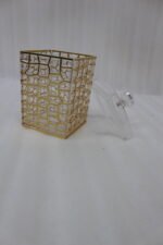 A luxury 3-piece clear acrylic jar set with gold geometric patterns and crystal lids, neatly arranged on a white marble kitchen countertop.