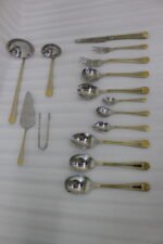 72-piece stainless steel cutlery set with gold trim handles and specialty serving utensils displayed on a white tray.