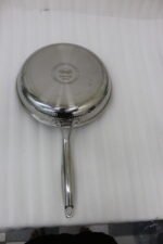 A 3-piece stainless steel cookware set with glass lids featuring 24CM, 26CM, and 28CM sizes displayed neatly on a kitchen counter.