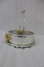 3-piece luxury silver decorative serving dishes with gold floral accents and metallic handles displayed on a wooden coffee table.