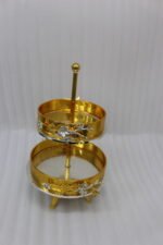 Luxury 2-tier gold decorative serving tray with silver floral accents on a wooden table