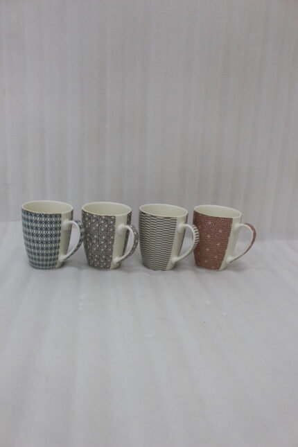 Set of four ceramic coffee mugs with unique geometric patterns in blue, grey, charcoal, and terracotta displayed on a kitchen counter.