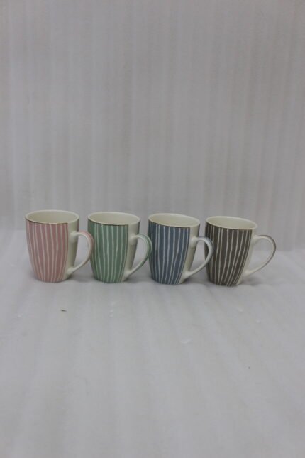 Four ceramic coffee mugs with pastel vertical stripes in pink, green, blue, and brown sitting on a marble kitchen countertop.