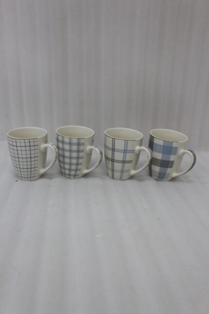 Set of 4 ceramic coffee mugs with blue and grey plaid grid patterns displayed on a kitchen countertop.