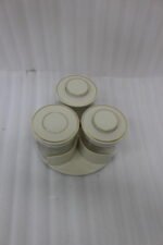 Four sets of ONE MORE 3-piece glass spice jars with trays sitting on a white marble countertop in beige, off-white, white, and black colors.