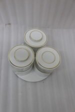 Four sets of ONE MORE 3-piece glass spice jars with trays sitting on a white marble countertop in beige, off-white, white, and black colors.
