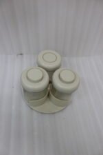 Four modern glass spice jar sets in black, tan, cream, and off-white with gold lid rings arranged on a marble kitchen countertop.
