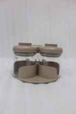 Four modern glass spice jar sets in black, tan, cream, and off-white with gold lid rings arranged on a marble kitchen countertop.