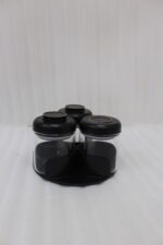 Four modern glass spice jar sets in black, tan, cream, and off-white with gold lid rings arranged on a marble kitchen countertop.