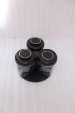 Four modern glass spice jar sets in black, tan, cream, and off-white with gold lid rings arranged on a marble kitchen countertop.