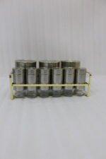 9-piece brushed stainless steel and glass spice jar set with gold rim accents arranged on a gold metal countertop rack