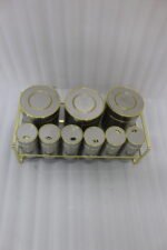 9-piece brushed stainless steel and glass spice jar set with gold rim accents arranged on a gold metal countertop rack