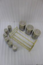 9-piece brushed stainless steel and glass spice jar set with gold rim accents arranged on a gold metal countertop rack