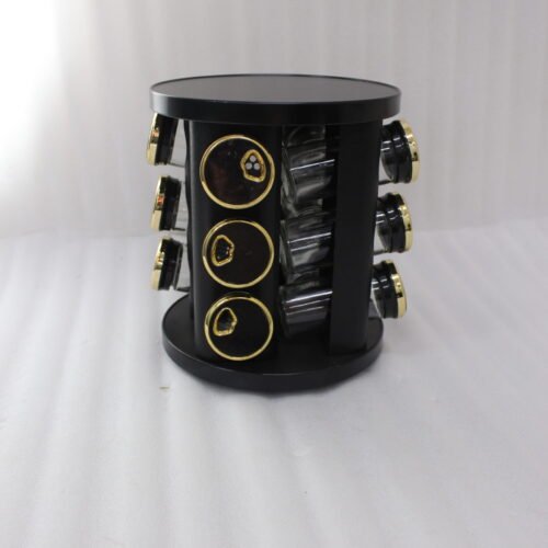 Modern 12-piece rotating black and gold spice rack organizer with glass jars on a white marble kitchen countertop