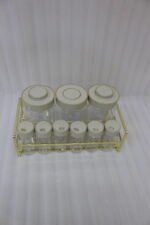 9-piece clear glass spice jar set with grey lids and a gold wire countertop rack