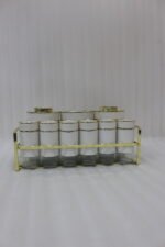 9-piece white ceramic and clear glass spice jar set with gold accents arranged in a gold metal rack on a marble countertop