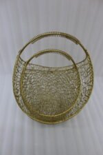 Add a touch of contemporary elegance to your interior with these handcrafted gold metal mesh baskets. Featuring an intricate, lacy wirework weave paired with a smooth rounded silhouette and a textured, coiled carry handle, these decorative baskets seamlessly balance functionality and aesthetic charm. Whether placed on a coffee table, console, or shelf, they work beautifully as standalone accents or stylish organizers for small accessories, fruit, or faux floral arrangements. Key Points Intricate Mesh Design: Features a unique, openwork woven metal texture in a luxurious warm gold finish. Ergonomic Handles: Designed with top curved handles wrapped in coiled wire detailing for an elevated look and comfortable grip. Versatile Accent: Ideal for living rooms, dining tables, entryways, or office desk organization. Set of Two Sizes: Comes in two complementary sizes for easy nesting, layered styling, or multi-room display. Durable Construction: Crafted from sturdy, high-quality metal to ensure long-lasting durability and style.