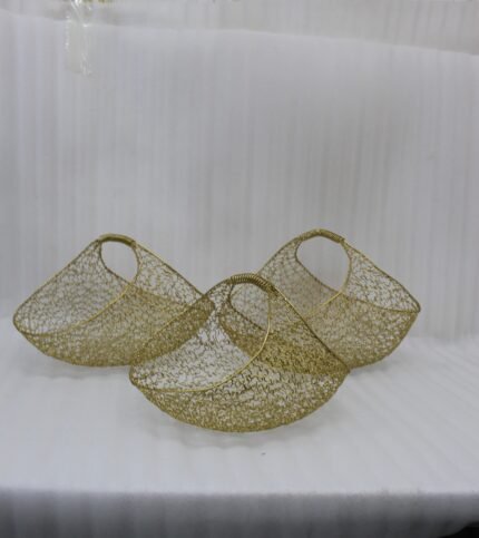 Set of three gold mesh wire decorative metal baskets displayed on a marble countertop with minimalist décor