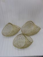 Set of three gold mesh wire decorative metal baskets displayed on a marble countertop with minimalist décor