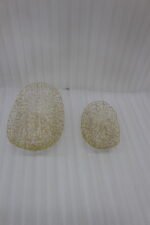 Set of two gold wire decorative metal baskets sitting on a wooden kitchen island counter