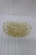 Set of two gold wire decorative metal baskets sitting on a wooden kitchen island counter