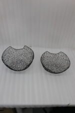 Set of two modern black wire mesh decorative baskets sitting on a wooden kitchen island countertop.