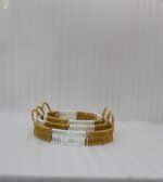 Three-piece round handwoven rattan serving tray set with white and tan woven edges and wooden bases on a light wood table.