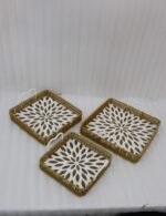 3-piece handwoven rattan serving tray set with white floral printed base and white handles on a wooden table.