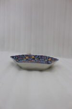 Decorative Marrakesh ceramic serving dish with colorful Moroccan mosaic pattern resting on a wooden dining table.