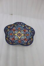 Decorative Marrakesh serving dish with a colorful ceramic mandala pattern and wavy edges on a wooden table