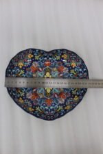 Decorative Marrakesh ceramic serving dish with colorful bohemian mandala pattern resting on a white marble kitchen countertop