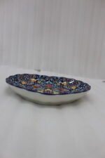 Decorative Marrakesh ceramic serving dish with colorful bohemian mandala pattern resting on a white marble kitchen countertop