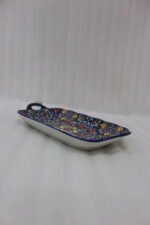Intricate vibrant blue and yellow Marrakech ceramic serving dish tray with built-in handles on a stone countertop