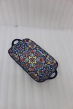 Intricate vibrant blue and yellow Marrakech ceramic serving dish tray with built-in handles on a stone countertop