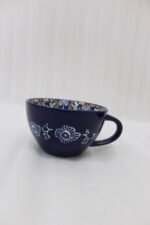 Royal blue handcrafted Marrakech ceramic mug with intricate floral interior pattern sitting on a kitchen counter