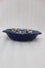 9.5-inch decorative Marrakech oval ceramic serving bowl with intricate blue, orange, and yellow hand-painted floral patterns resting on a marble countertop