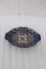 9.5-inch decorative Marrakech oval ceramic serving bowl with intricate blue, orange, and yellow hand-painted floral patterns resting on a marble countertop