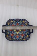Square ceramic 6-inch Marrakesh decorative bowl with vibrant floral mandala pattern and side handles sitting on a wooden table.