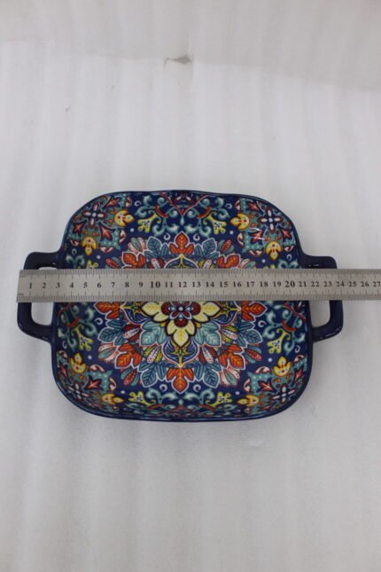 Square ceramic 6-inch Marrakesh decorative bowl with vibrant floral mandala pattern and side handles sitting on a wooden table.